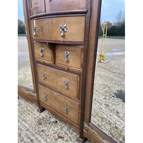 244 - Shapland & Petter, Barnstaple, a triple section walnut wardrobe circa 1900, Art Nouveau inlaid throu... 