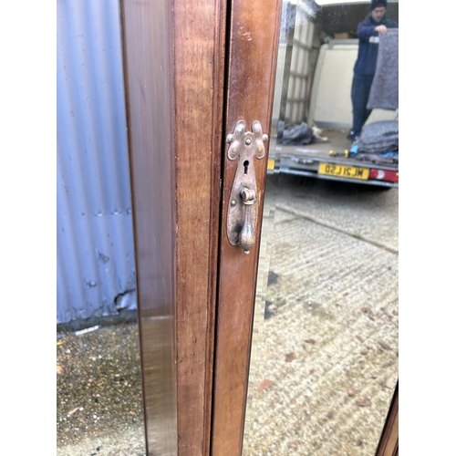 244 - Shapland & Petter, Barnstaple, a triple section walnut wardrobe circa 1900, Art Nouveau inlaid throu... 