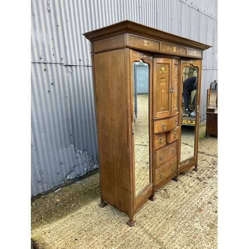 244 - Shapland & Petter, Barnstaple, a triple section walnut wardrobe circa 1900, Art Nouveau inlaid throu... 