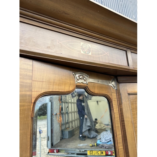 244 - Shapland & Petter, Barnstaple, a triple section walnut wardrobe circa 1900, Art Nouveau inlaid throu... 