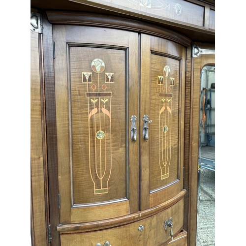 244 - Shapland & Petter, Barnstaple, a triple section walnut wardrobe circa 1900, Art Nouveau inlaid throu... 