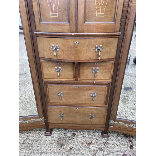 244 - Shapland & Petter, Barnstaple, a triple section walnut wardrobe circa 1900, Art Nouveau inlaid throu... 