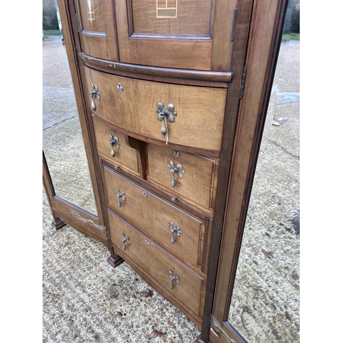 244 - Shapland & Petter, Barnstaple, a triple section walnut wardrobe circa 1900, Art Nouveau inlaid throu... 