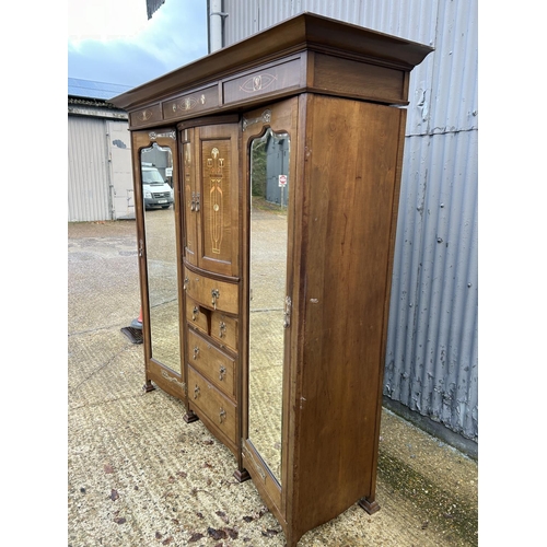 244 - Shapland & Petter, Barnstaple, a triple section walnut wardrobe circa 1900, Art Nouveau inlaid throu... 