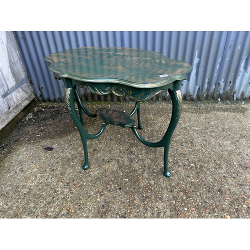 254 - A green and gold painted fern pattern occasional table. 107 x 72 x 72 cms tall