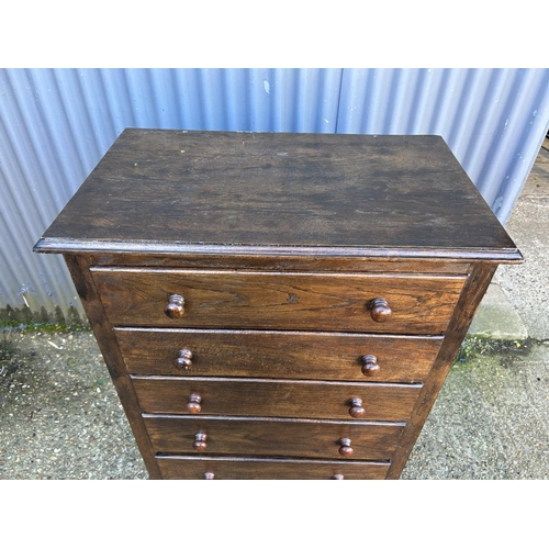 42 - An oak tallboy chest of six drawers
