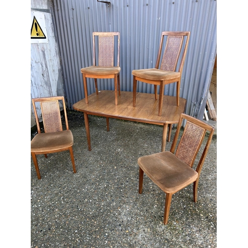 48 - A mid century g plan teak extending dining table together with four g plan dining chairs