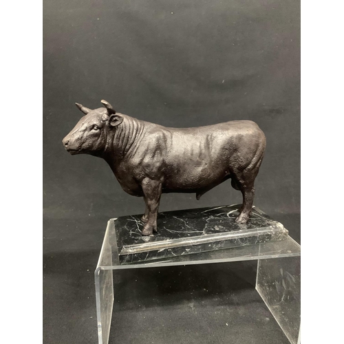 433 - Bronze bull on marble effectplinth, overall length 26cms, height 17cms