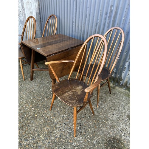 187 - A dark ercol drop leaf dining table together with four ercol stick back chairs