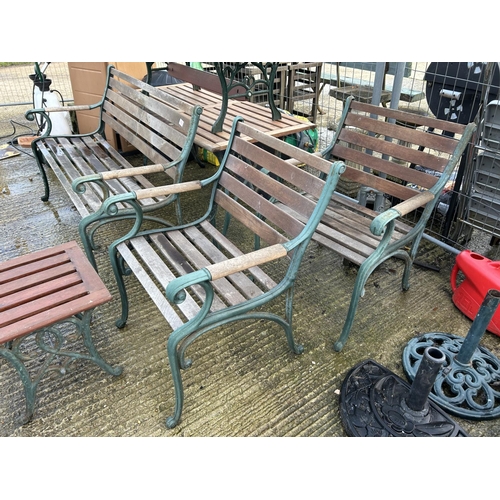 402 - An iron framed garden furniture suite consisting a bench seat, two carver chairs, a wine table, a fl... 