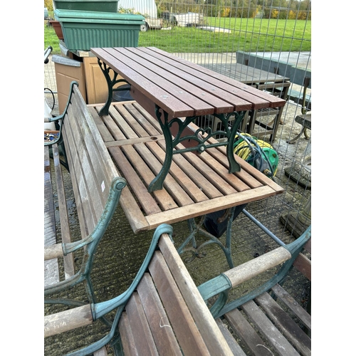 402 - An iron framed garden furniture suite consisting a bench seat, two carver chairs, a wine table, a fl... 