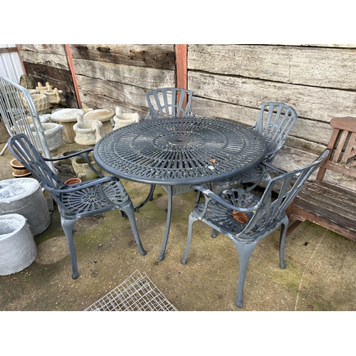 407 - A large ornate circular aluminum garden table and four carver chairs