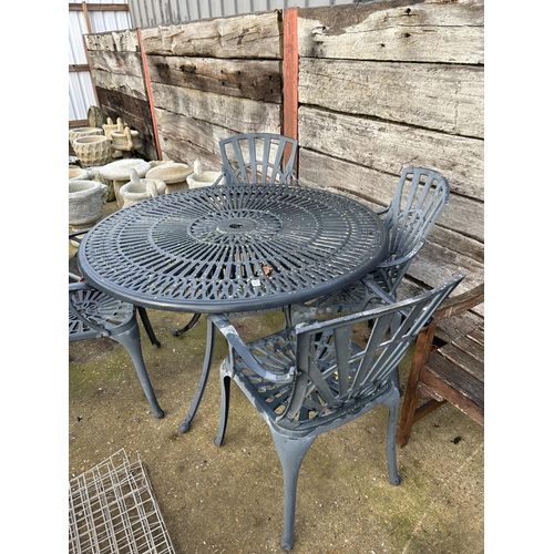 407 - A large ornate circular aluminum garden table and four carver chairs