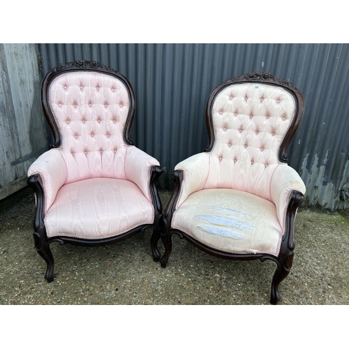 246 - An ornate pair of mahogany framed button back chairs with pink upholstery