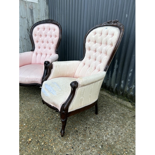 246 - An ornate pair of mahogany framed button back chairs with pink upholstery