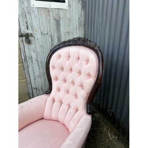 246 - An ornate pair of mahogany framed button back chairs with pink upholstery