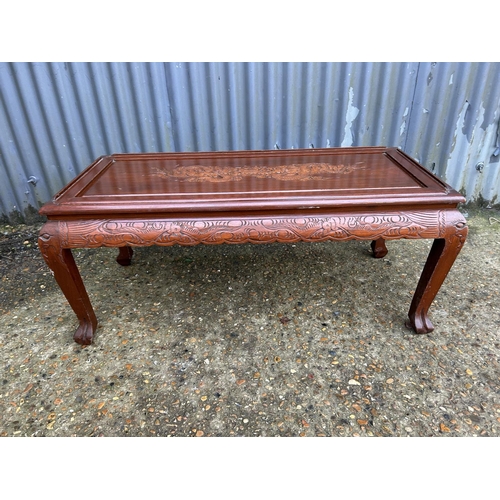 253 - A carved oriental hardwood coffee table 104x50x45