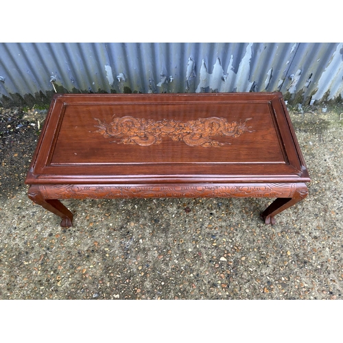 253 - A carved oriental hardwood coffee table 104x50x45