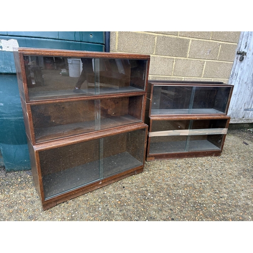 254 - A minty style oak three section glazed stacking bookcase together with a similar oak two section boo... 