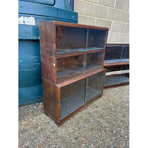 254 - A minty style oak three section glazed stacking bookcase together with a similar oak two section boo... 