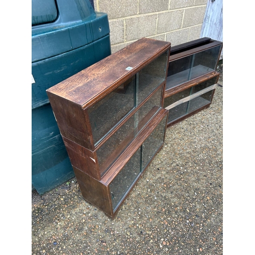 254 - A minty style oak three section glazed stacking bookcase together with a similar oak two section boo... 