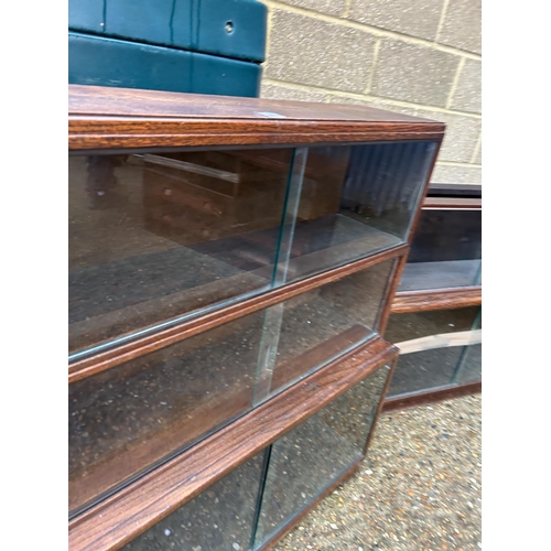 254 - A minty style oak three section glazed stacking bookcase together with a similar oak two section boo... 