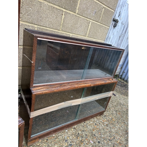 254 - A minty style oak three section glazed stacking bookcase together with a similar oak two section boo... 