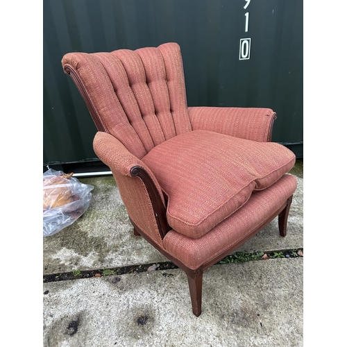 257 - A red upholstered button back armchair