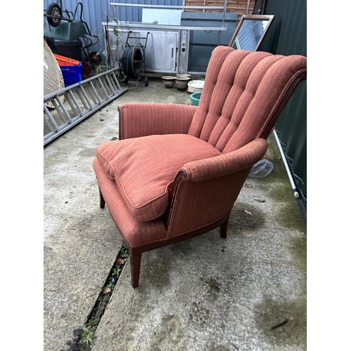 257 - A red upholstered button back armchair