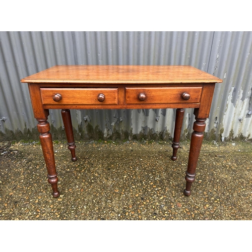 108 - A Victorian mahogany two drawer writing table 89x45x70