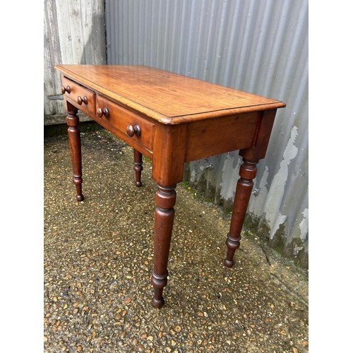 108 - A Victorian mahogany two drawer writing table 89x45x70