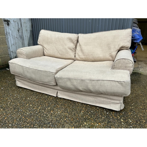 112 - A hessian upholstered two seater sofa