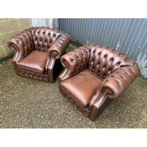 113 - A pair of brown leather chesterfield club armchairs (one arm AF)