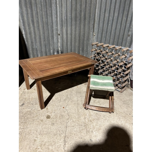 149 - A hardwood garden table, wine rack and folding stool