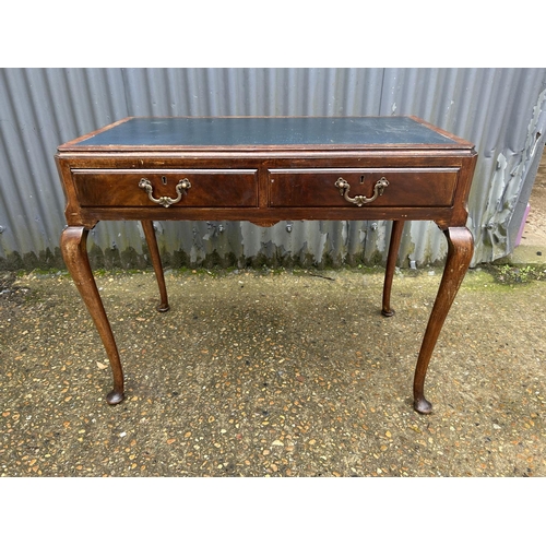 169 - A mahogany two drawer writing table 93x50x77
