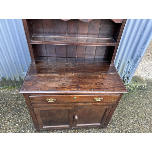 17 - An antique oak dresser with platerack top over single drawer base 90x51x190