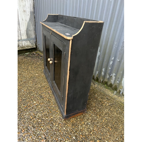 184 - A black and gold painted pine hall cupboard 103x30x100