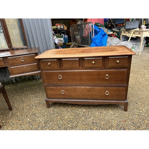 204 - A suite of stag minstrel bedroom furniture including dressing table, stool, chest of three and a bed... 