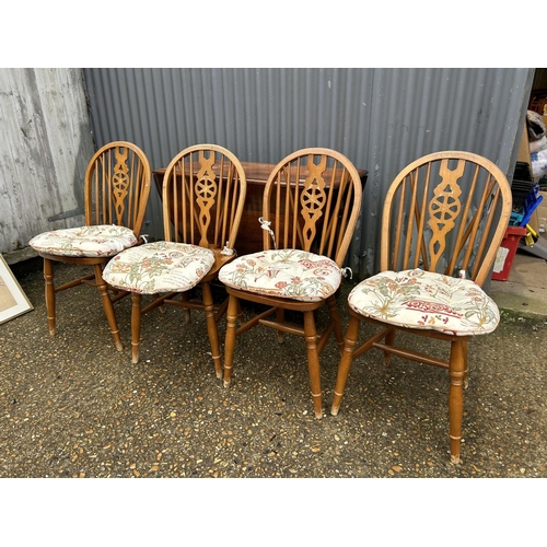 210 - An oak gateleg table together with four wheelback dining chairs