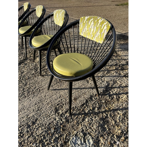 21a - A set of four Black stick back Vitra style designer chairs with Green Upholstery