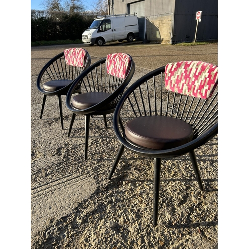 21b - A set of four Black stick back Vitra style designer chairs with pink Upholstery
