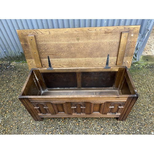22 - A carved oak blanket box by OLD CHARM 115x46x50
