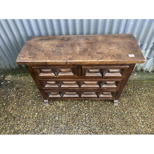 25 - A dark gothic style pine chest of four 100x37x70