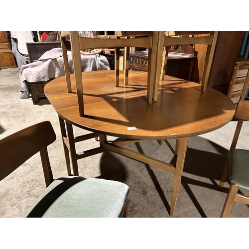 28 - A retro light oak drop leaf table with four chairs