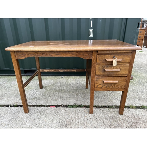 281 - A vintage oak three drawer typist desk 121x69x77