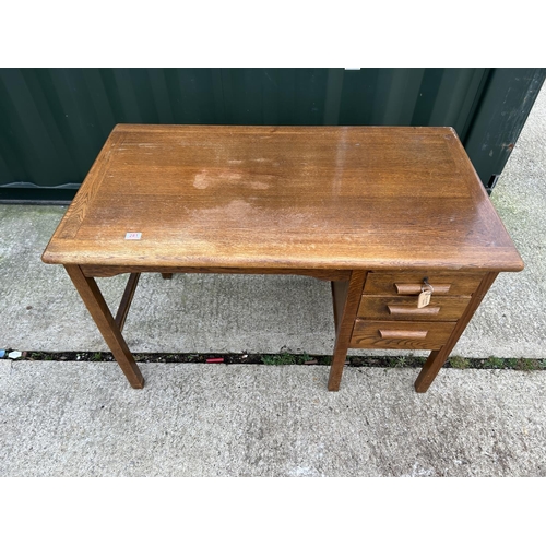 281 - A vintage oak three drawer typist desk 121x69x77