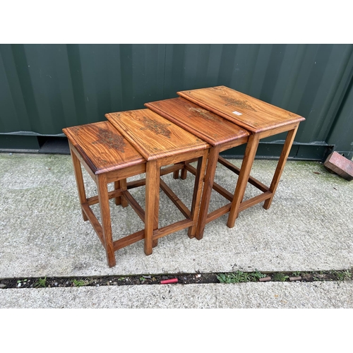 283 - A hardwood nest of four occasional tables with brass inlaid top