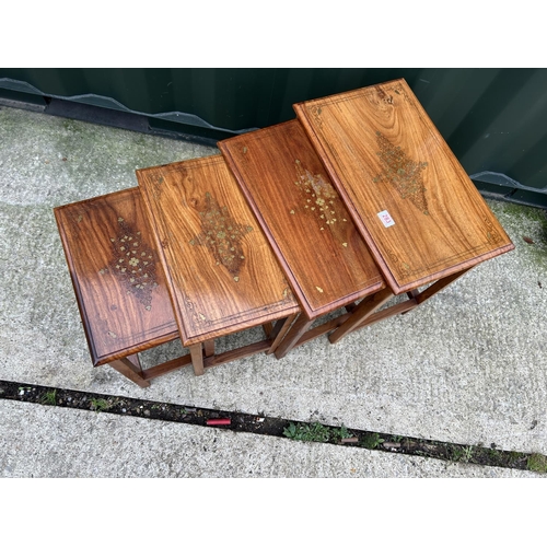 283 - A hardwood nest of four occasional tables with brass inlaid top