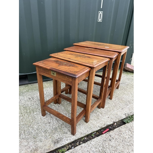 283 - A hardwood nest of four occasional tables with brass inlaid top