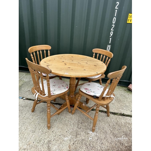 284 - A circular pine kitchen table together with four pine chairs 97cm diameter